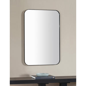 Glencoe Wall Mirror mounted on a wall above a table, displaying a modern interior setting
