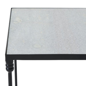 Close-up of the Giulia table's gray stone top and black metal edges.