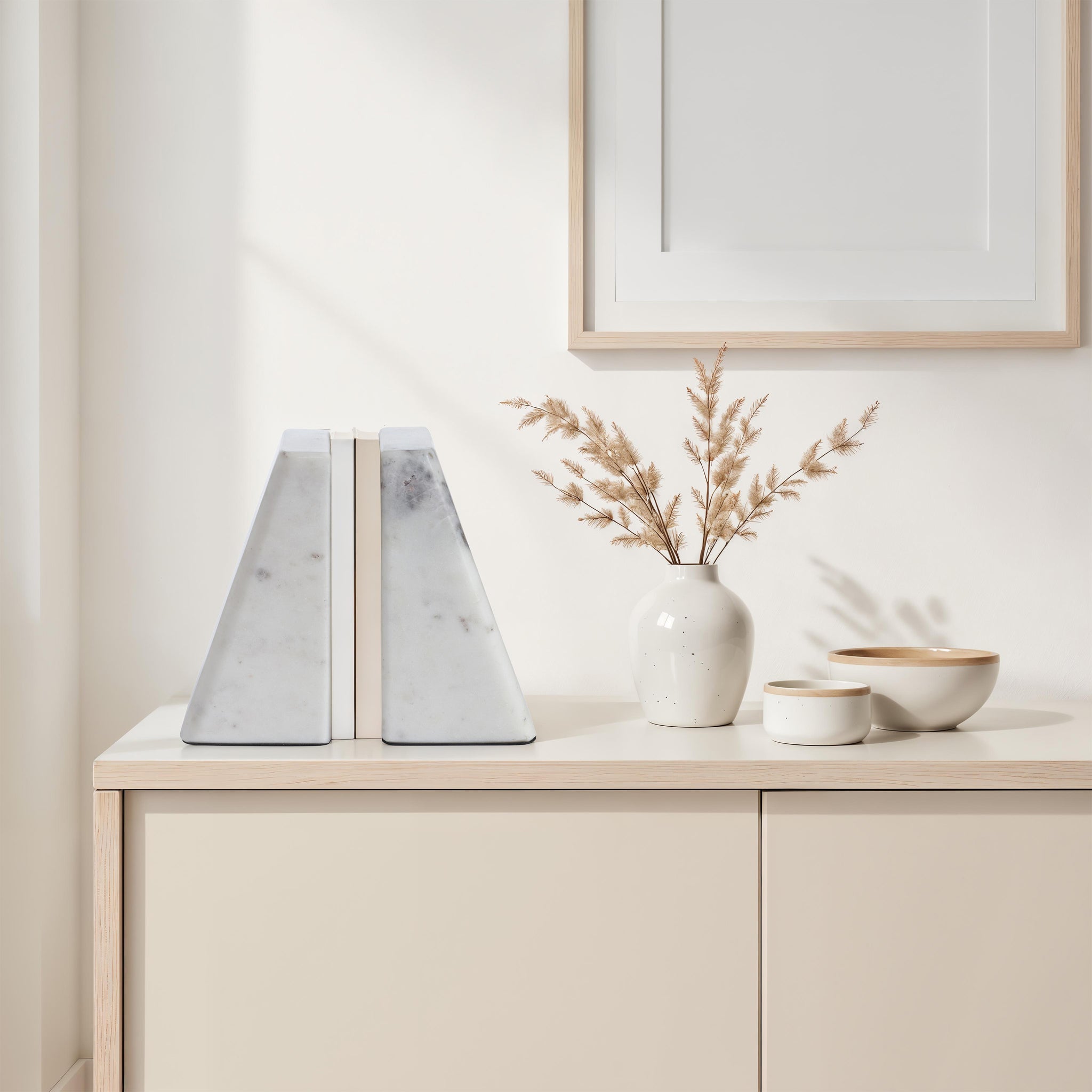 Carvella Statue bookends in Banswara marble, styled on a modern shelf with decorative items.