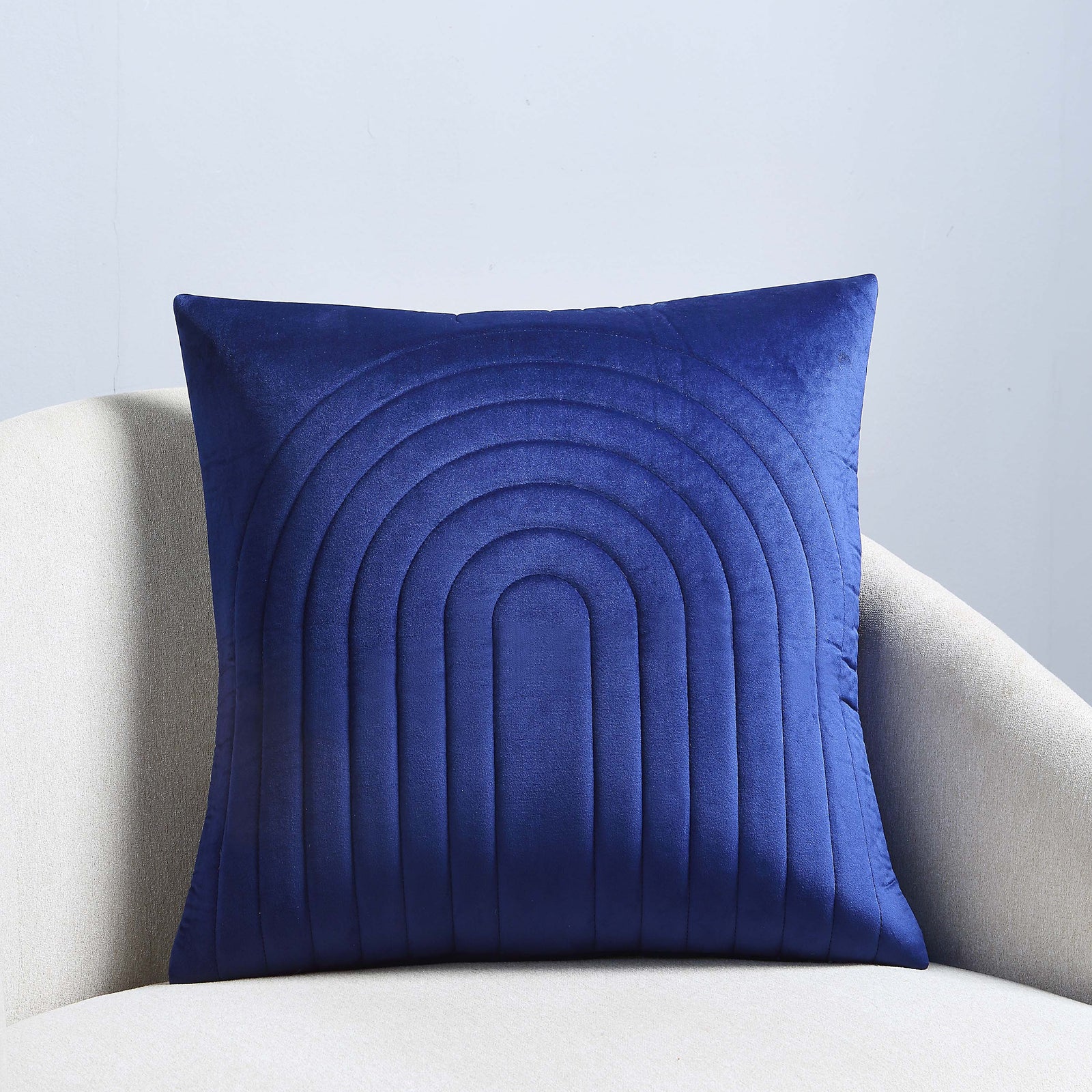 Pichu indoor pillow in navy blue with quilted rainbow pattern.