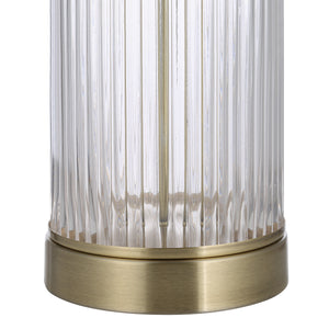 Close-up of Ocala Table Lamp's ribbed glass base with a brass accent