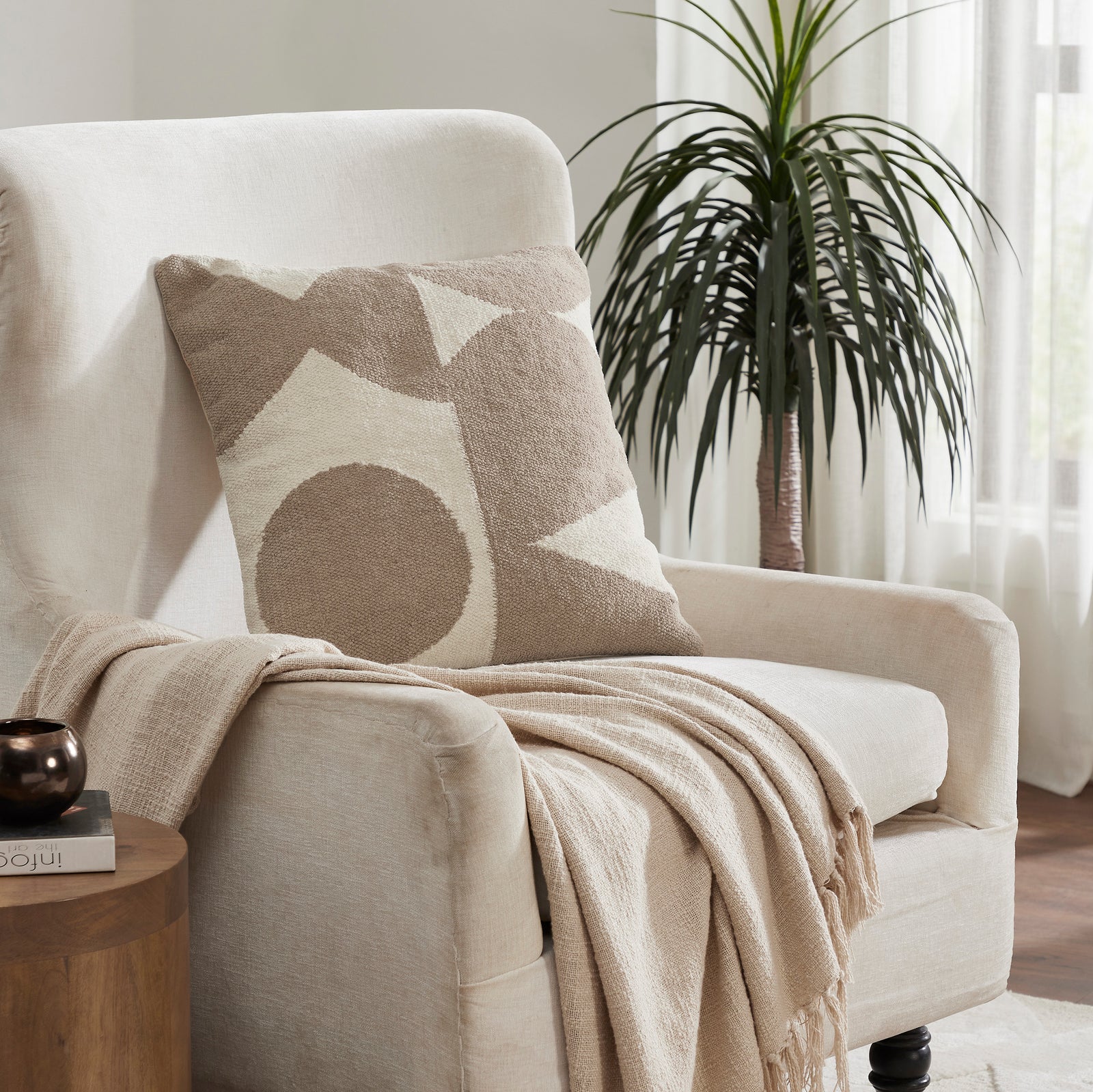 Ferla Indoor Pillow featuring abstract shapes in beige and cream colors