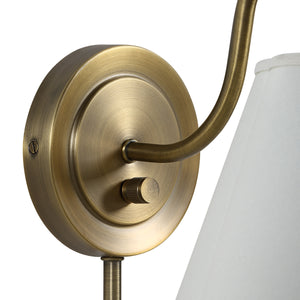 Close-up of Arielle wall sconce's brass mount and switch, highlighting its design.