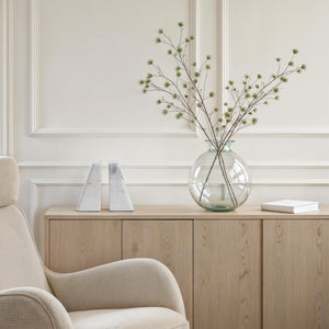 Carvella Statue bookends in Banswara marble, placed on a wooden cabinet with a vase and greenery.