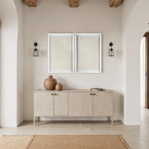 Marlon wall art displayed above a beige sideboard with decorative vases.