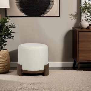 Chaves Ottoman by Renwil, placed next to a modern cabinet, cream upholstery and wood legs