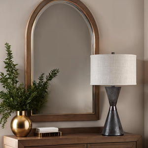 Vyara table lamp on a wooden console with a mirror and greenery