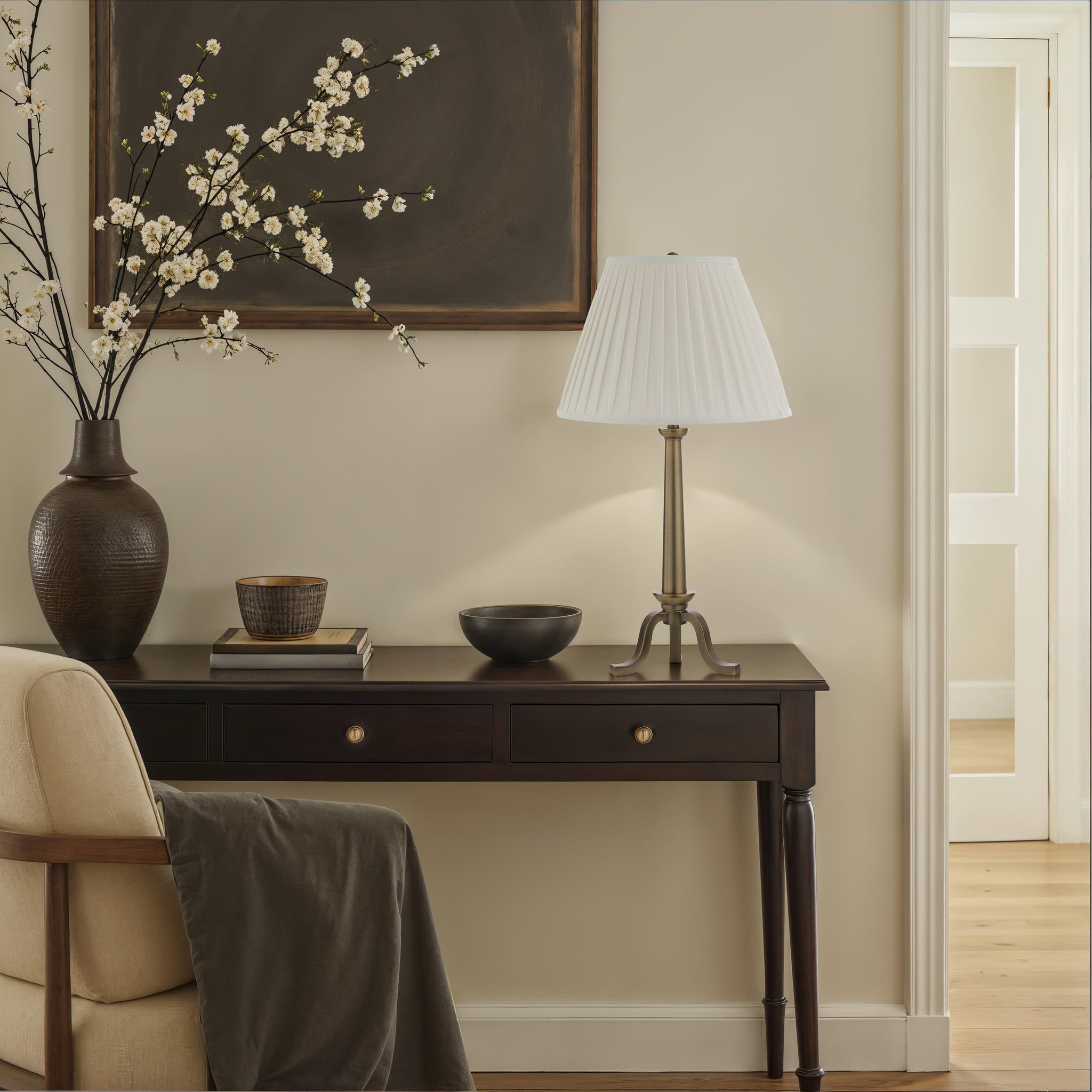 Lucerna Table Lamp styled on a console table with decorative items and flowers