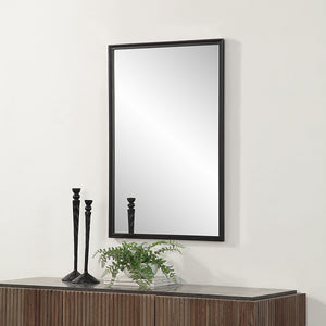 Lausanne Wall Mirror displayed above a wooden console, surrounded by decorative items.