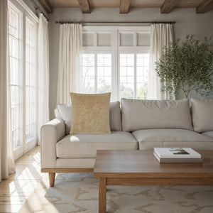 Oceana pillow by Renwil placed on a light sofa in a bright living room