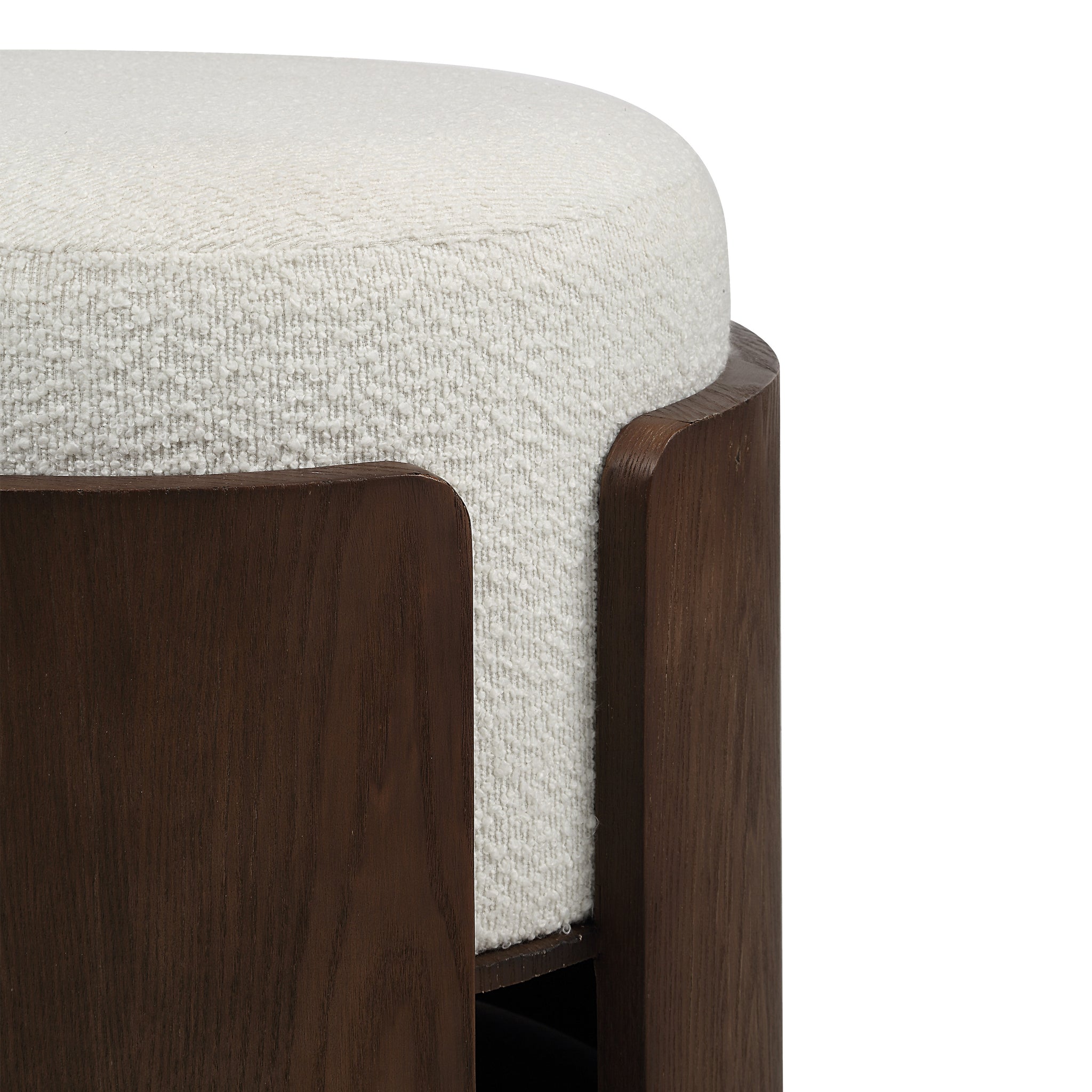Close-up of Capsula Ottoman showing cream textured top and dark wood edges