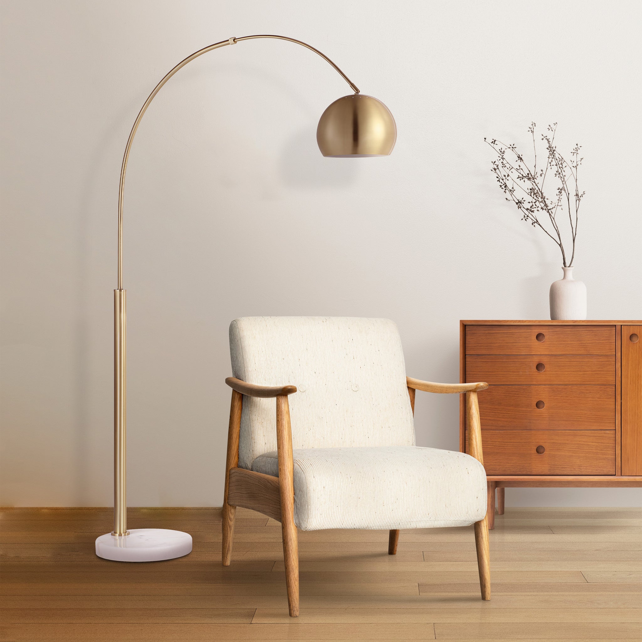 Daleela floor lamp in a living room setting next to a wooden chair and vase.