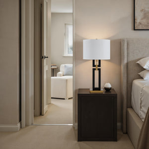 Lila Table Lamp on a nightstand in a cozy bedroom with neutral tones.
