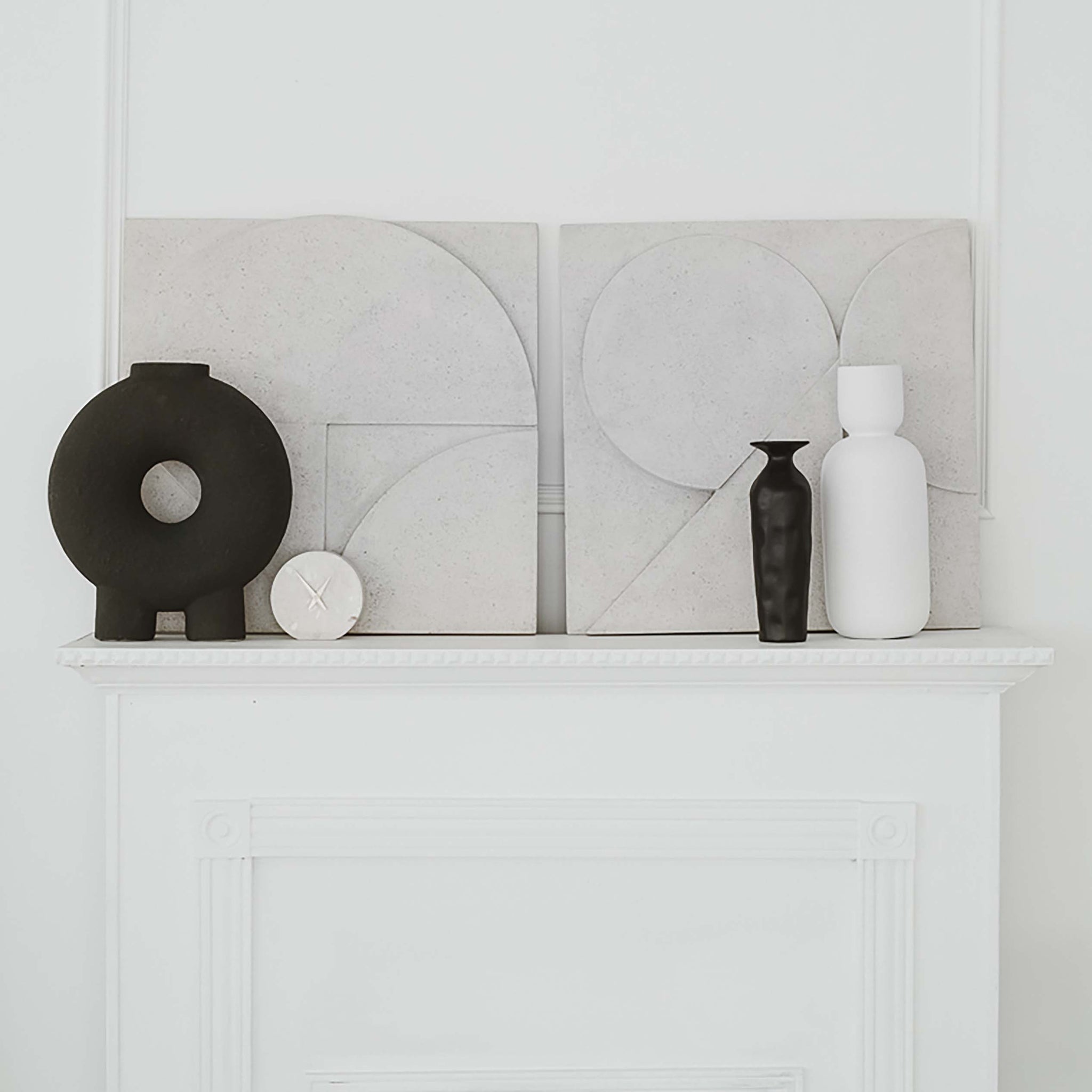 Sahara Wall Art styled on a mantel with decorative vases, featuring light gray concrete geometric shapes.