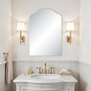 Erica mirror by Renwil installed in a bathroom, paired with gold sconces and marble countertop.