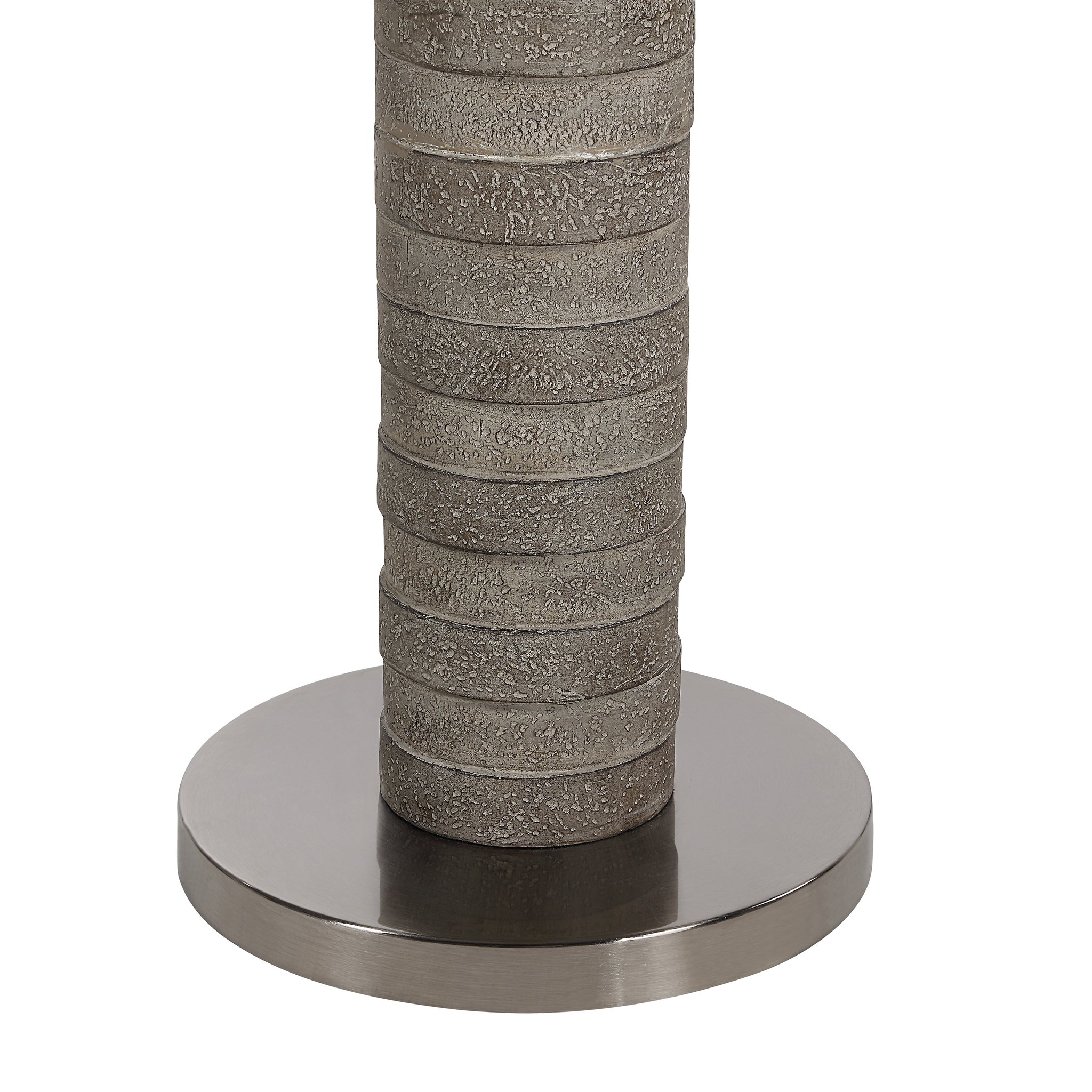 Close-up of Moringa floor lamp's gray textured base and metal circular base.