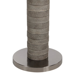Close-up of Moringa floor lamp's gray textured base and metal circular base.