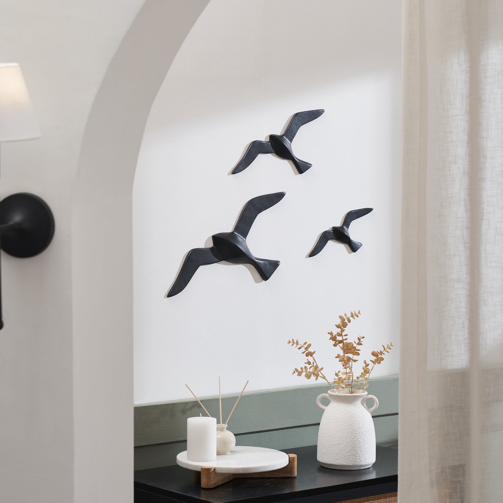 Stevens Wall Decor featuring three black bird sculptures in flight