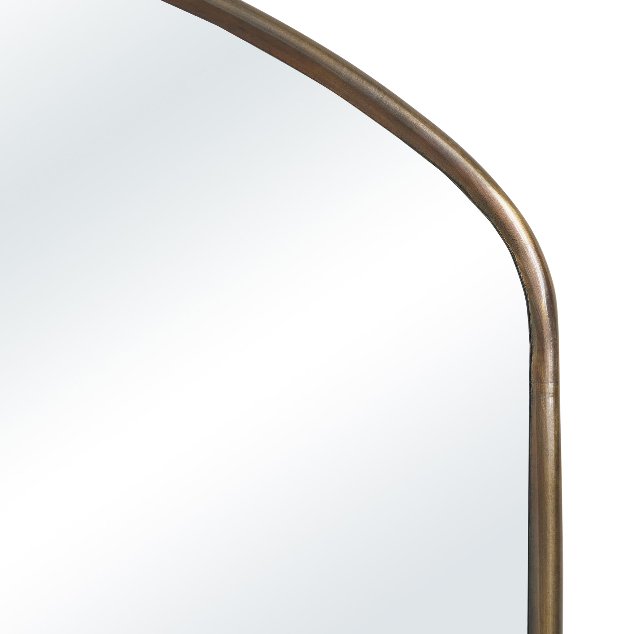 Close-up of Clarisse mirror featuring an arched design and a bronze frame.