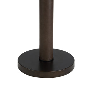 Base of the Incanta floor lamp showing a round dark bronze base and textured brown pole.