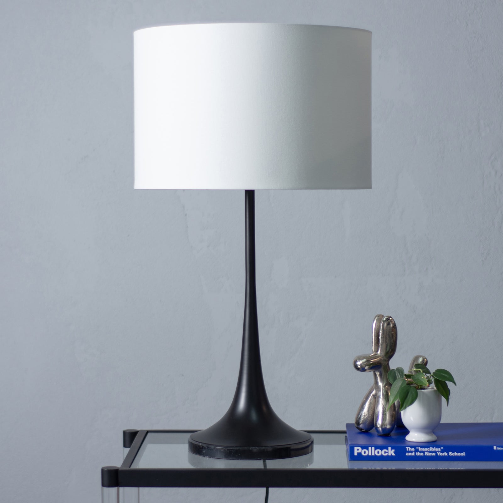 Salvora Table Lamp with a black base and a cream fabric shade, showcasing a modern design.