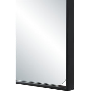 Close-up of the Maniola mirror's black frame and smooth edges.