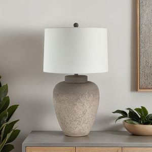 Lattuga table lamp on a modern side table with plants and artwork in the background
