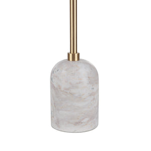Close-up of a Marchesa tapered candle holder featuring a marble base and gold metal stem