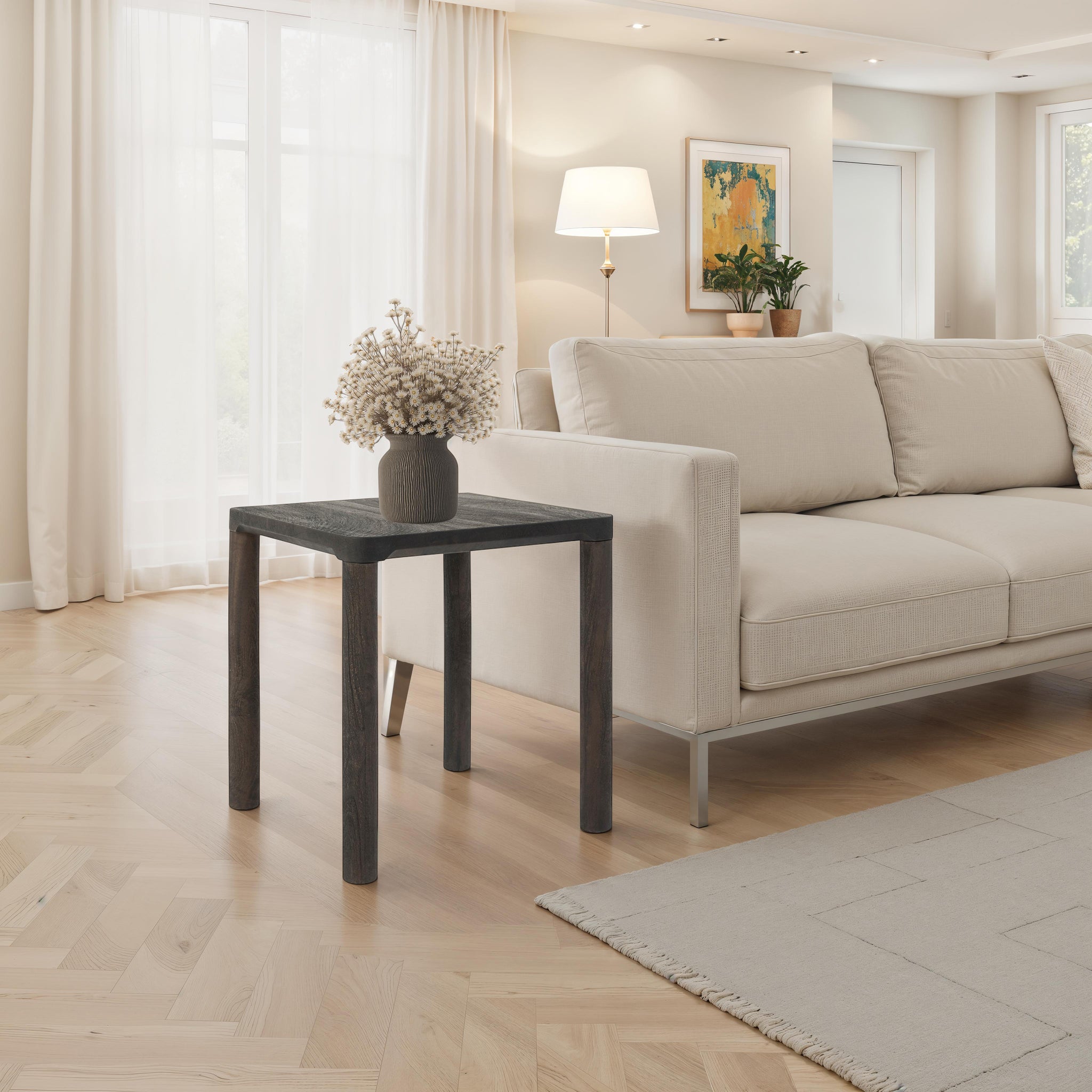 Clusia 19.0" Height Side Table placed beside a sofa, adorned with a decorative vase