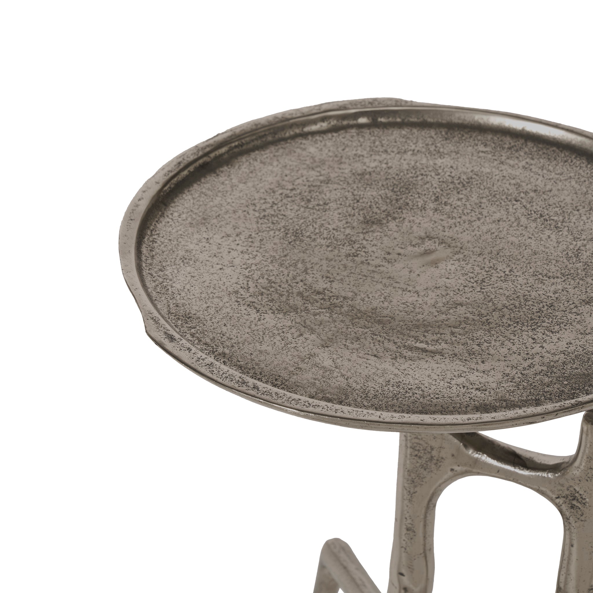 Close-up of Tosco table's round metallic top with textured surface in silver.
