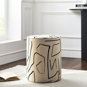Rachelle Stool in a bright room, beige fabric with black lines, beside a book