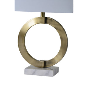 Skylar Table Lamp showcasing a brass circular frame and white shade from a side view.