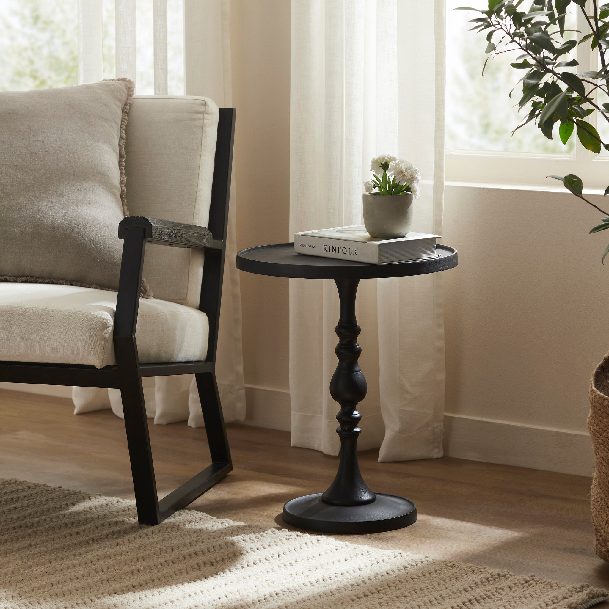 Yates Side Table styled beside a chair with a plant and books on top