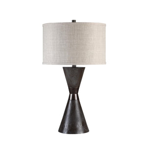 Vyara table lamp with a textured dark base and beige fabric shade