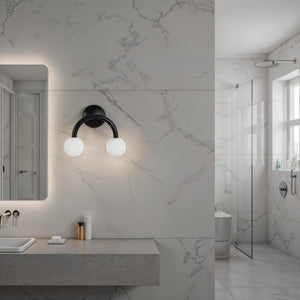 Santo wall sconce installed in a modern bathroom with marble walls
