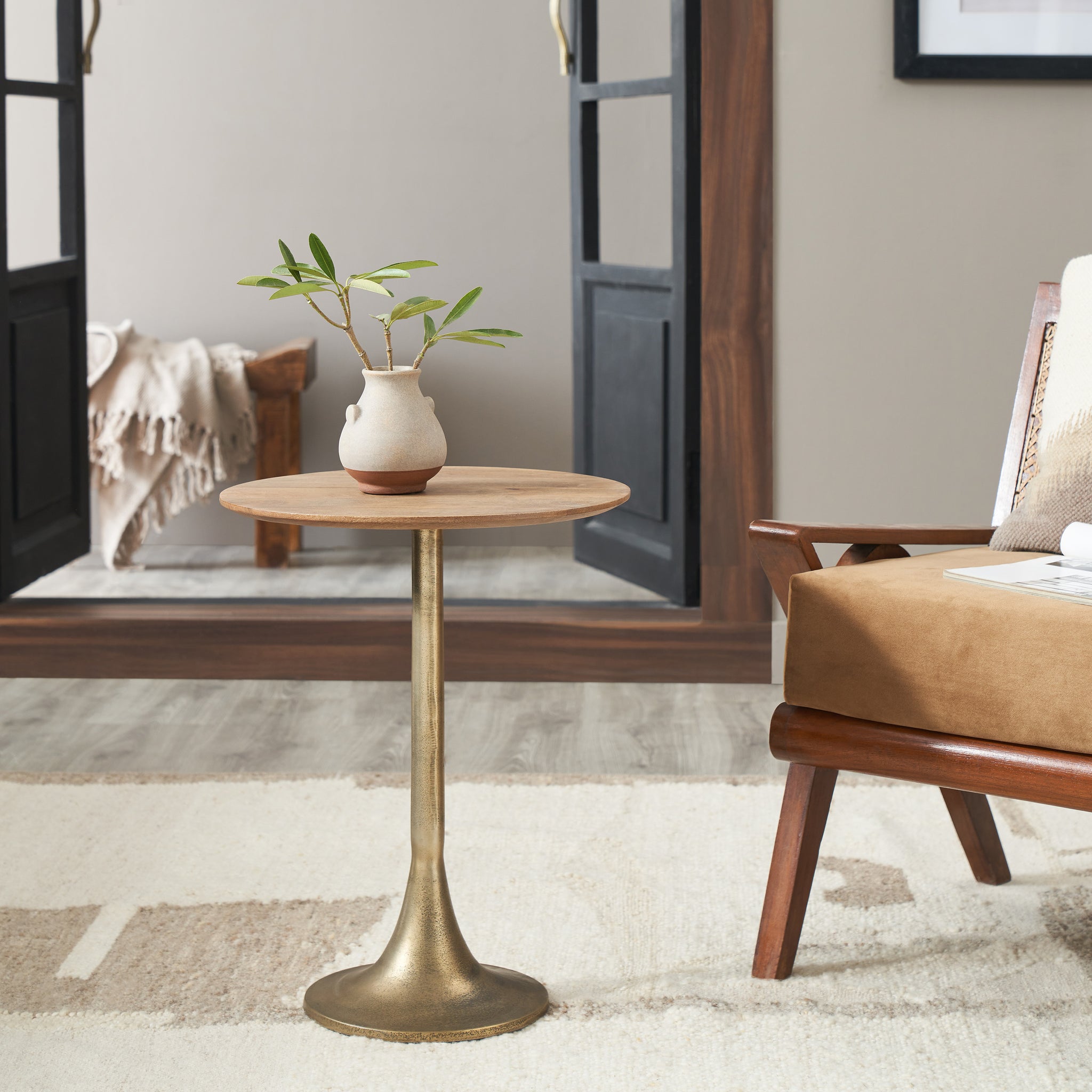 Sparta Accent Table styled with a vase and plant, set in a modern living room.