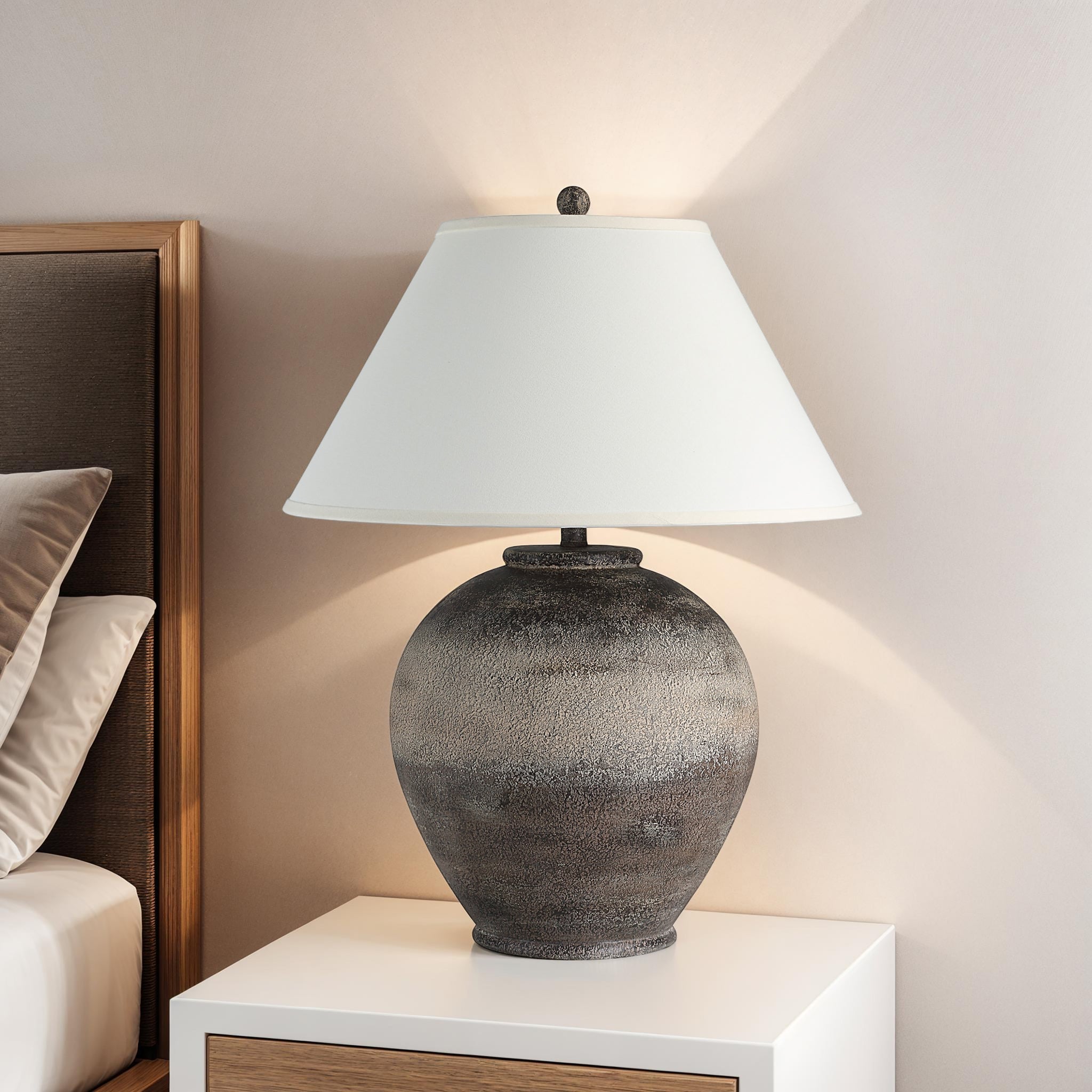 Bronce Table Lamp on a nightstand, illuminating a cozy bedroom with a white shade
