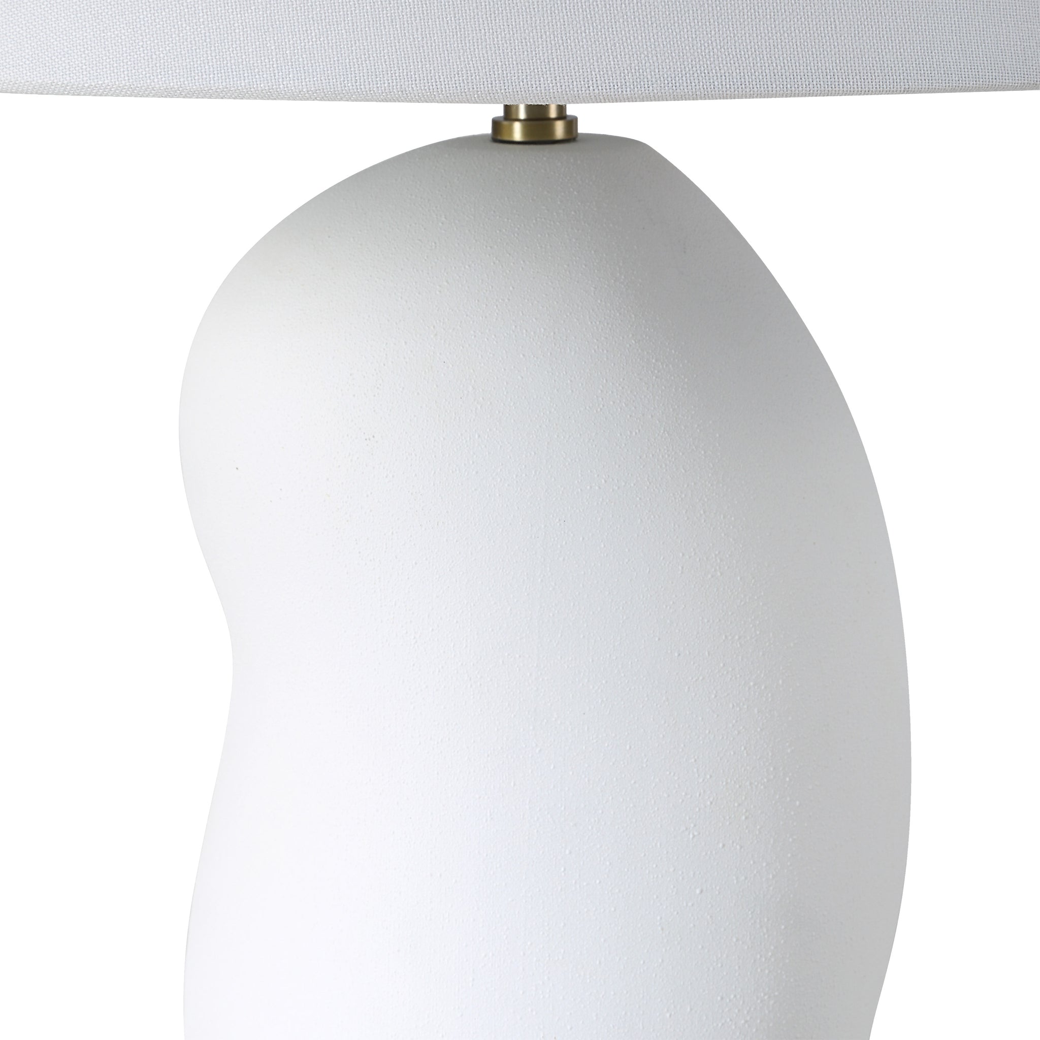 Katya Table Lamp close-up showing the white textured base and brass detail.