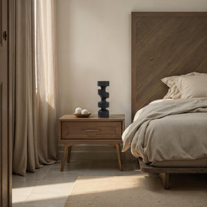 Beckton statue by Renwil on a bedside table, styled with neutral bedding and wooden furniture.