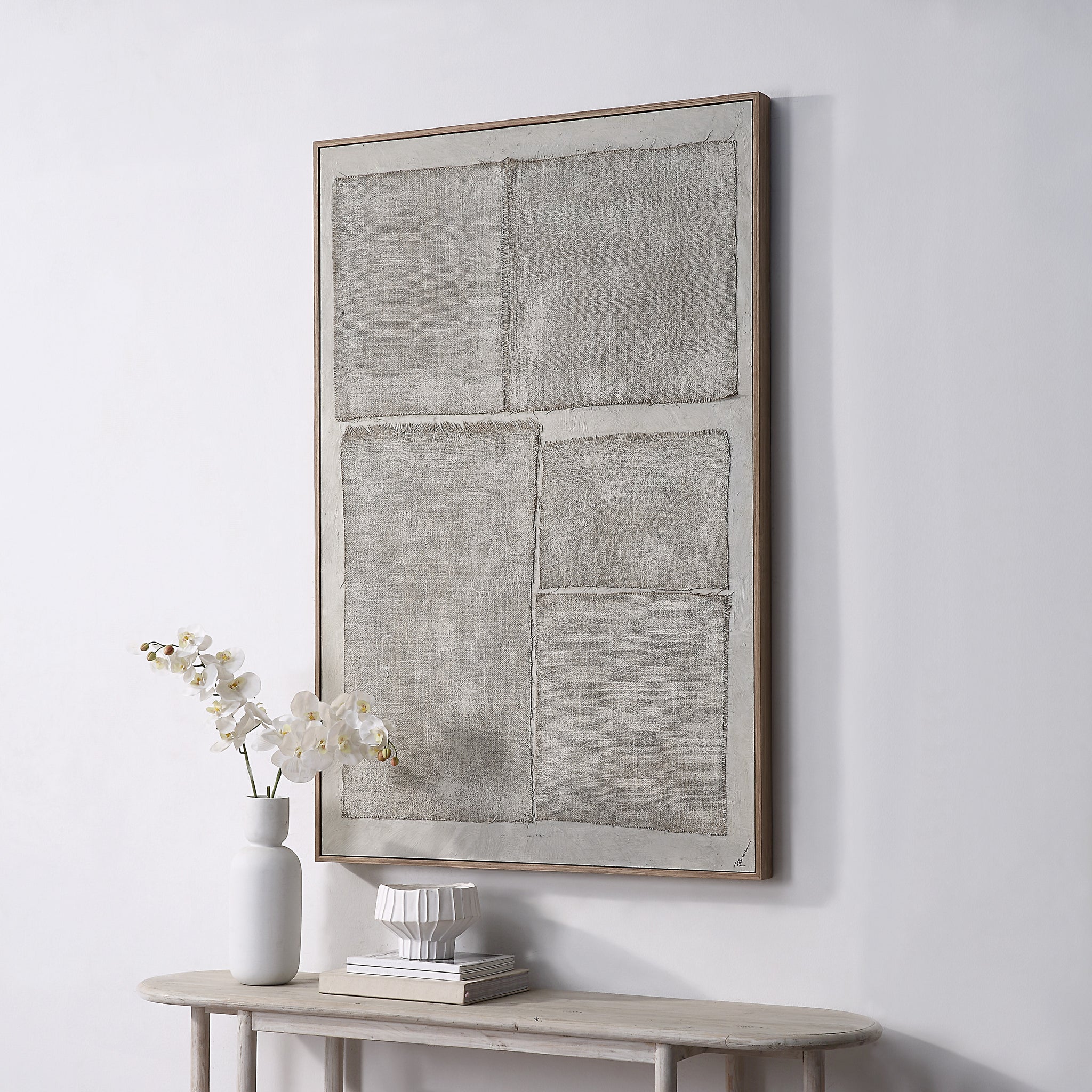 Picardy canvas art displayed on a wall above a table with decor items.
