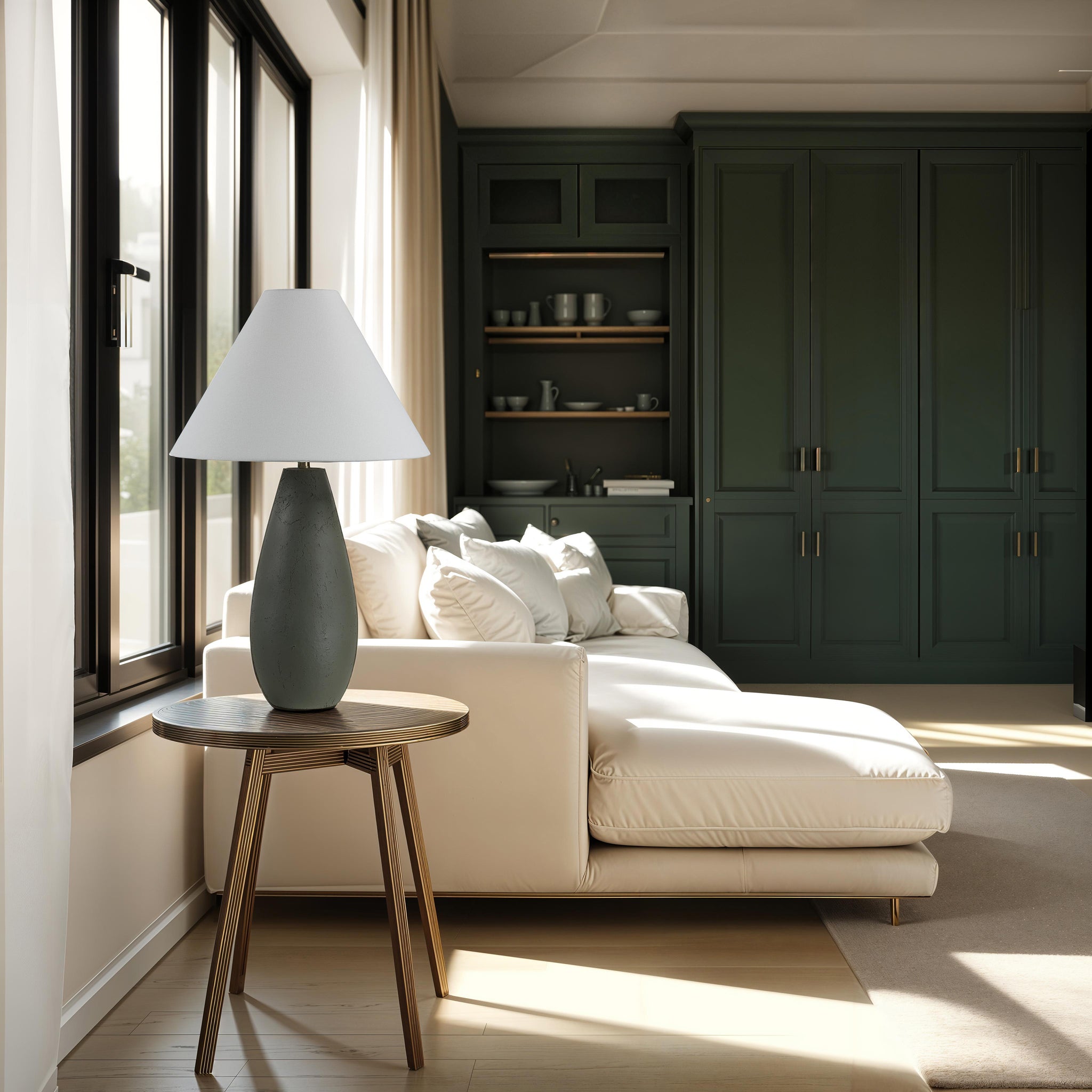 Olso Table Lamp on a round wooden side table next to a white sofa