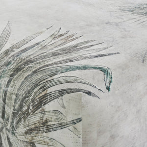 Close-up of Tangle Ottoman's botanical print fabric, showcasing intricate leaf details.