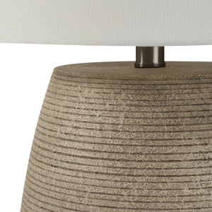 Close-up of Optima table lamp showcasing the beige textured base and white shade.