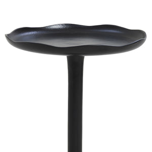 Close-up of Fiora side table's black flower-shaped top with a smooth finish.