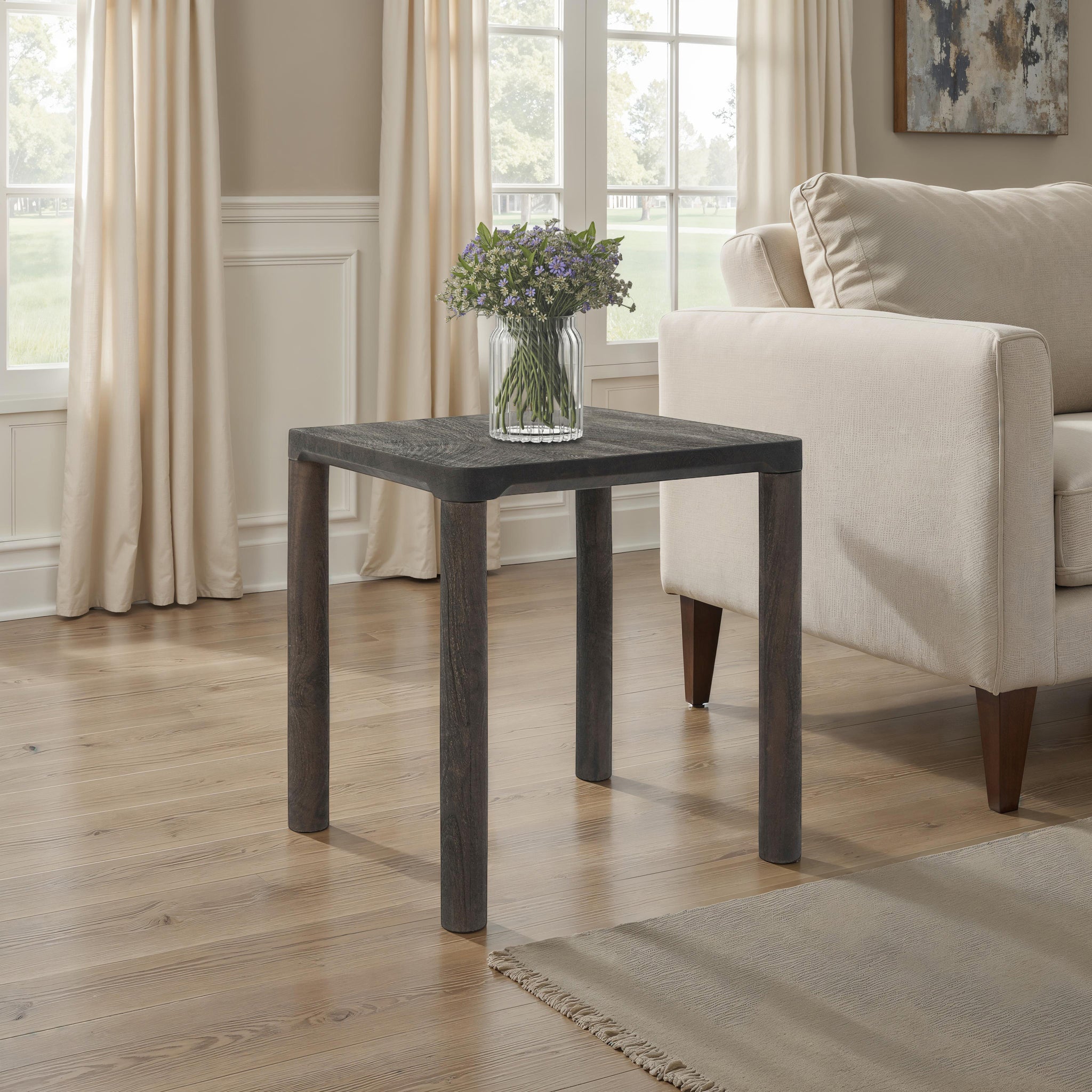 Clusia 19.0" Height Side Table styled in a living room with a vase of flowers on top