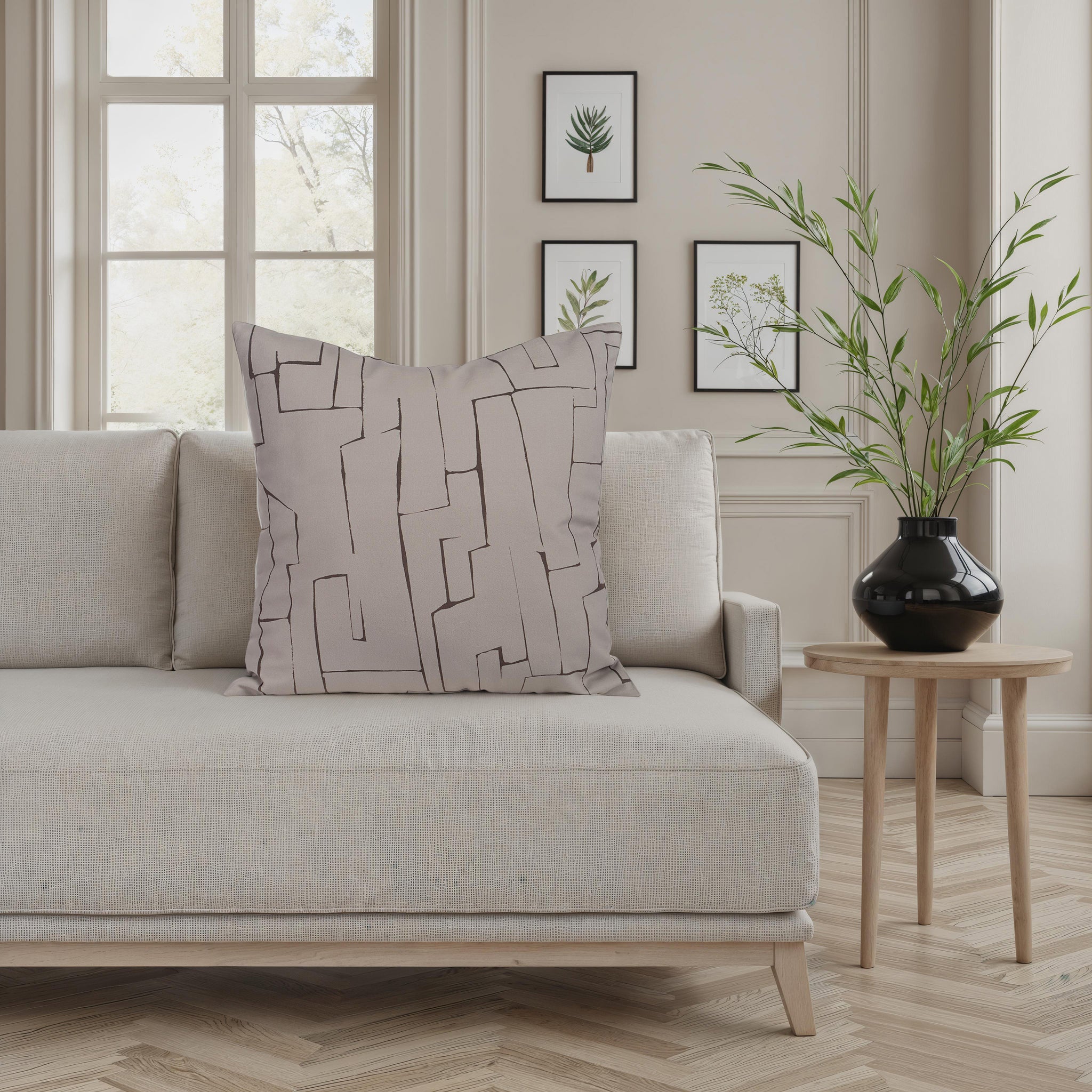 Sarno pillow displayed on a light sofa in a modern living room setting.