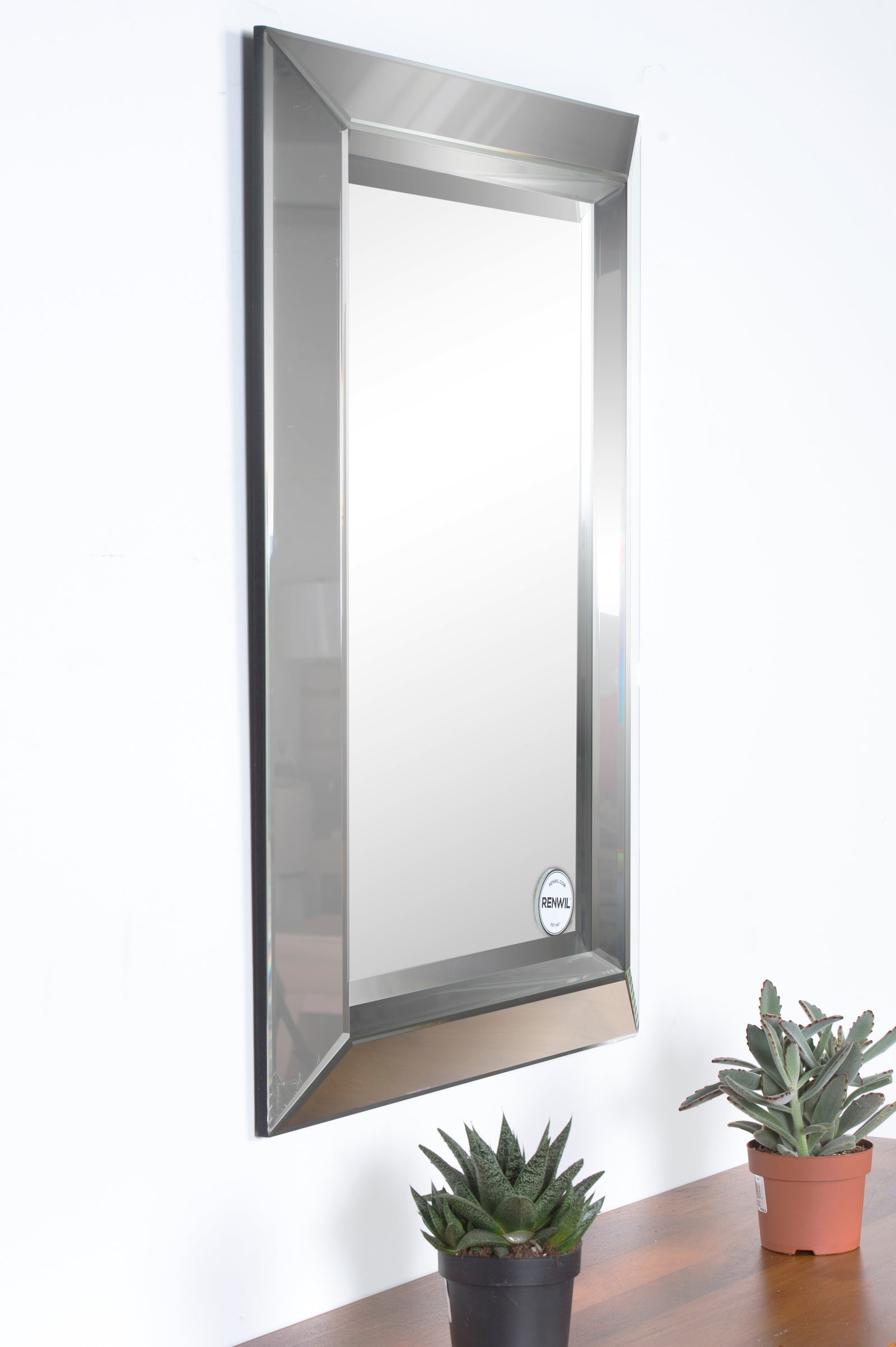 Aura Wall Mirror with a sleek rectangular design and mirrored frame, showcasing a polished surface.
