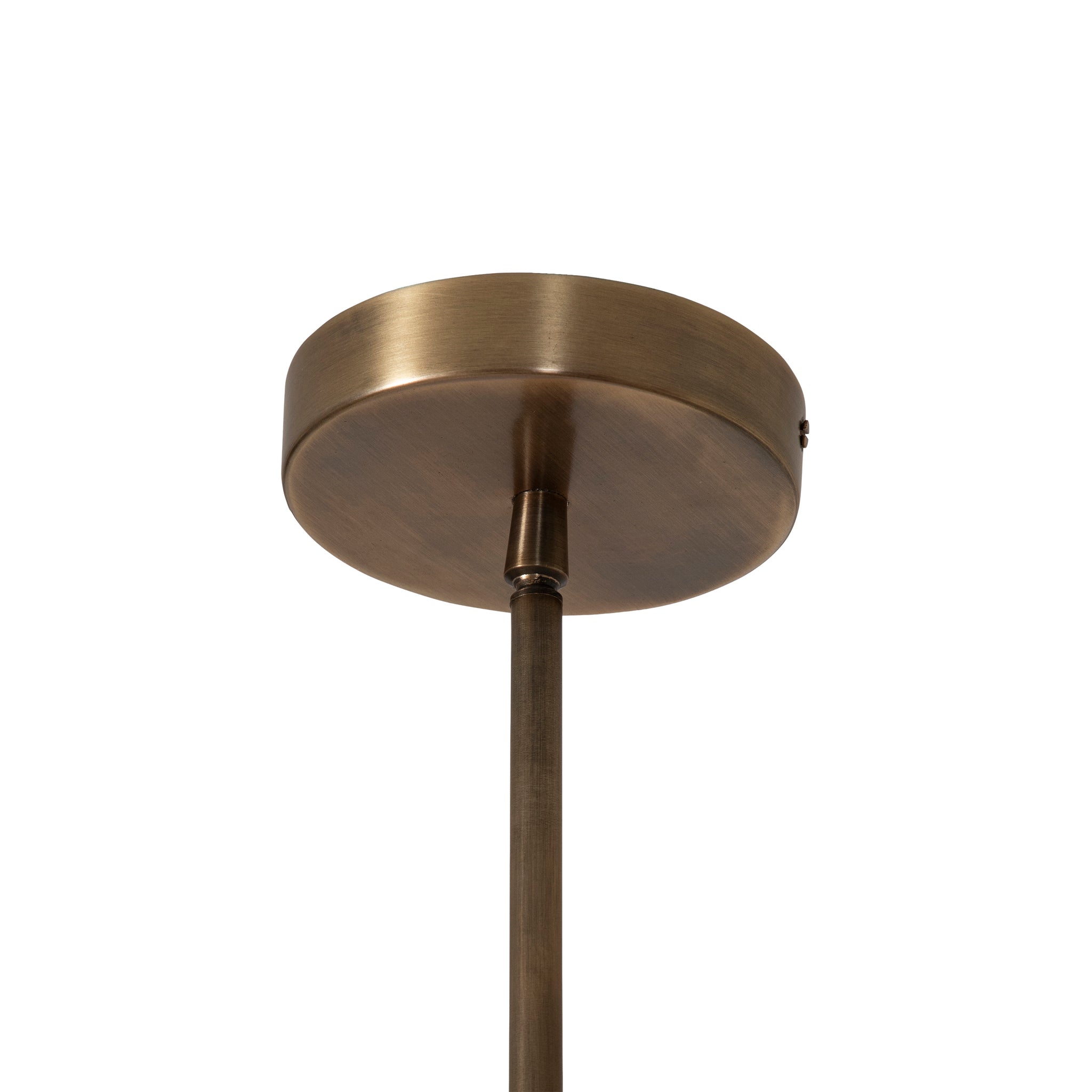 Brillio pendant light with a round antique brass canopy and slender rod, viewed from below against a white background.